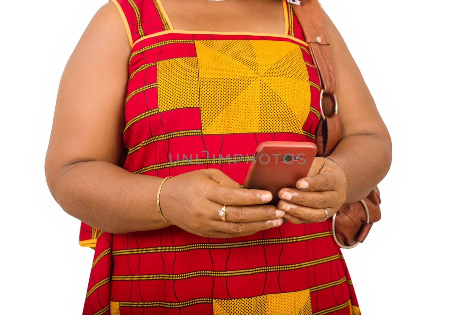 mature woman in loincloth standing on white background looking at mobile phone.