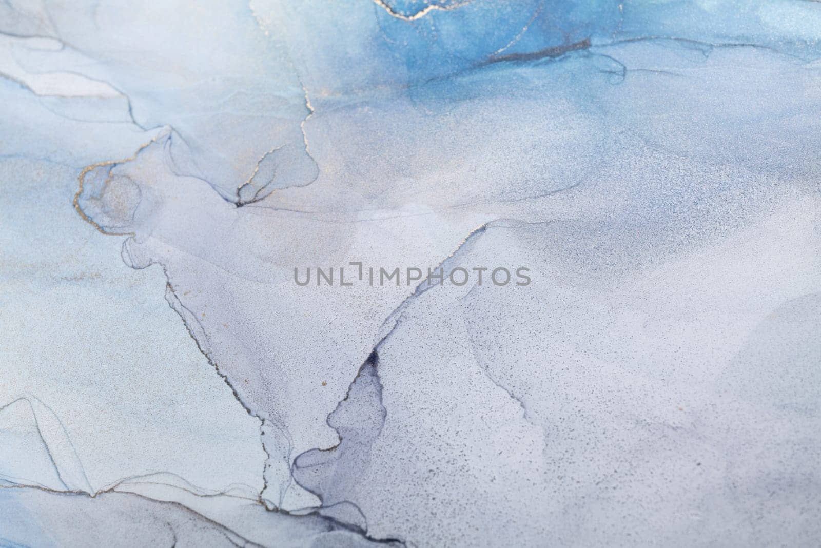 Blue and gold alcohol ink. Style incorporates the swirls of marble or the ripples of agate. Abstract painting, trendy background for wallpapers, posters, cards, invitations, websites.