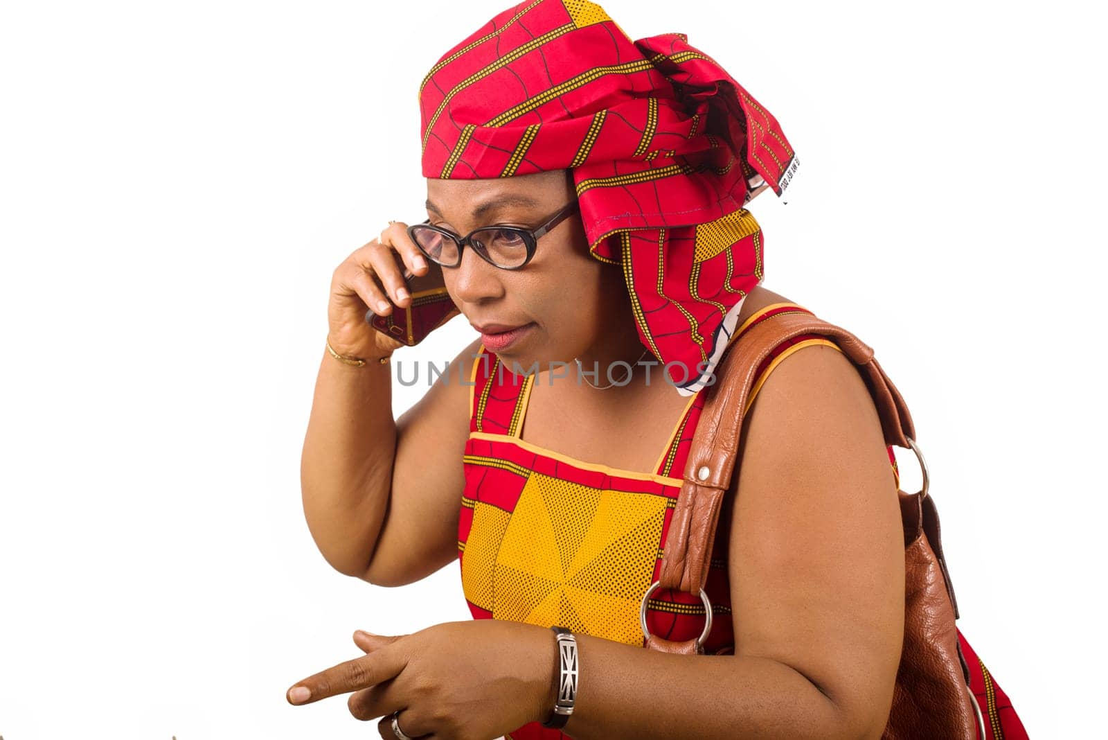 mature woman in loincloth standing on white background communicating on cellphone.