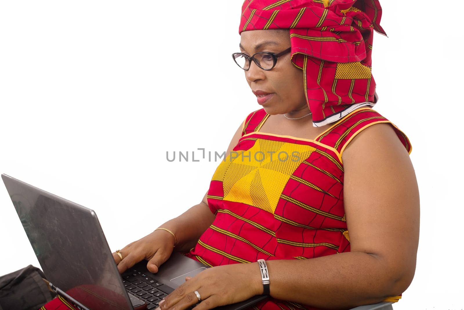 mature woman in loincloth on white background looking at laptop.