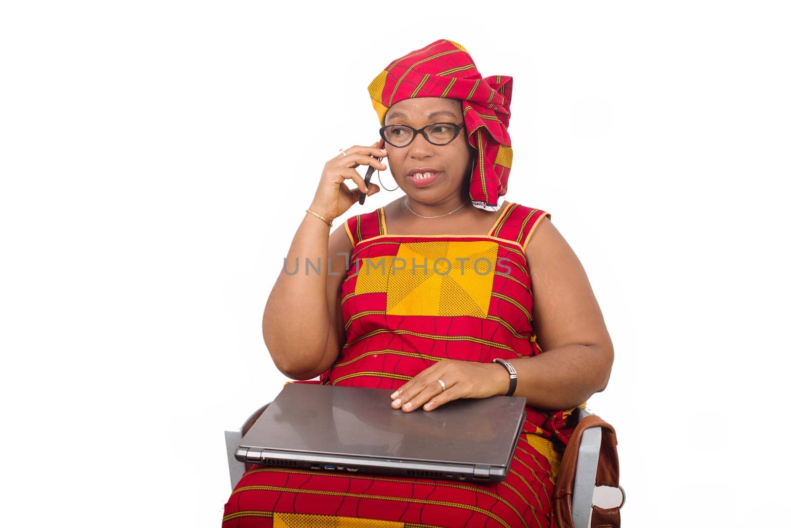 mature woman sitting in loincloth on white background communicating on mobile phone.