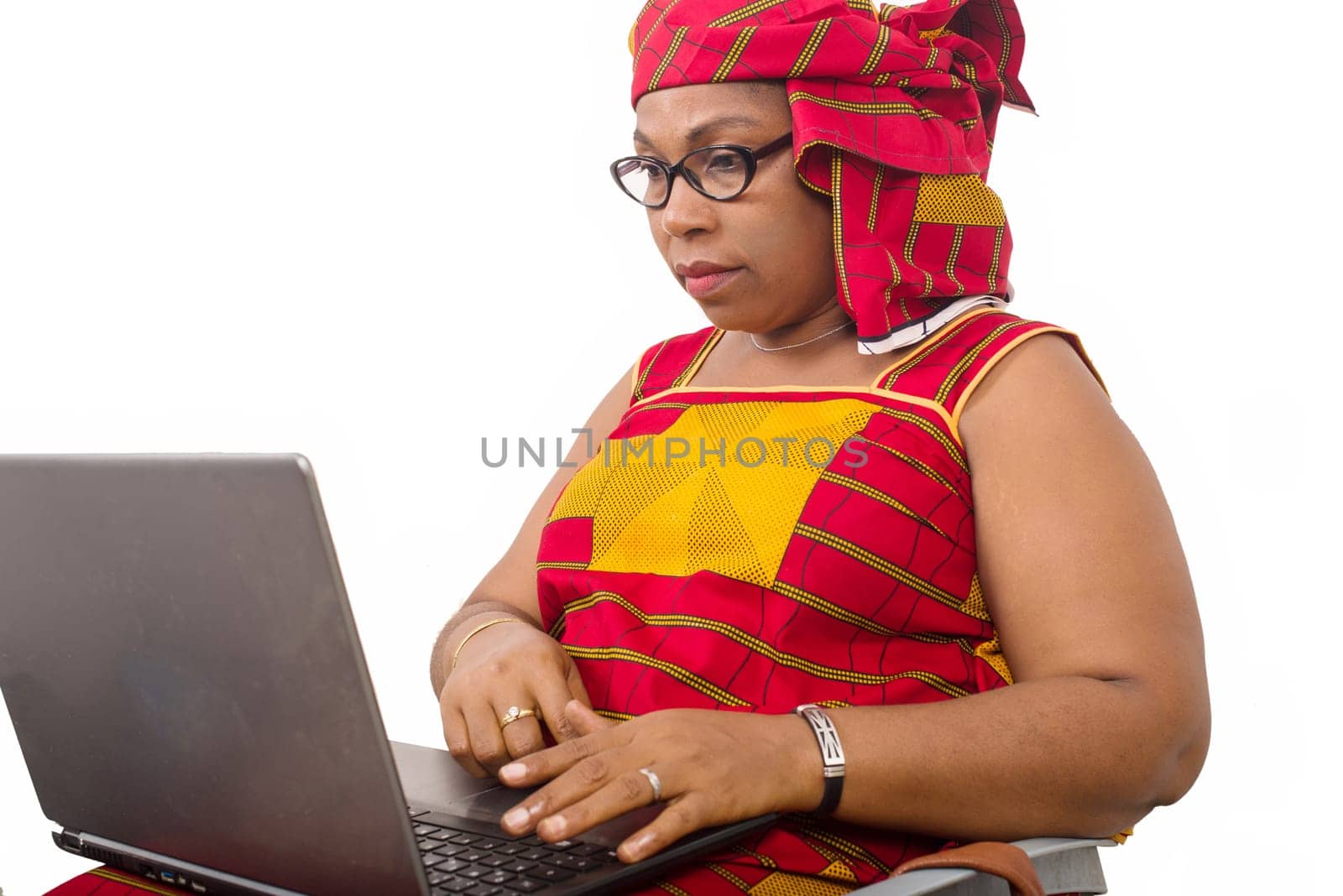 mature woman in loincloth on white background looking at laptop.