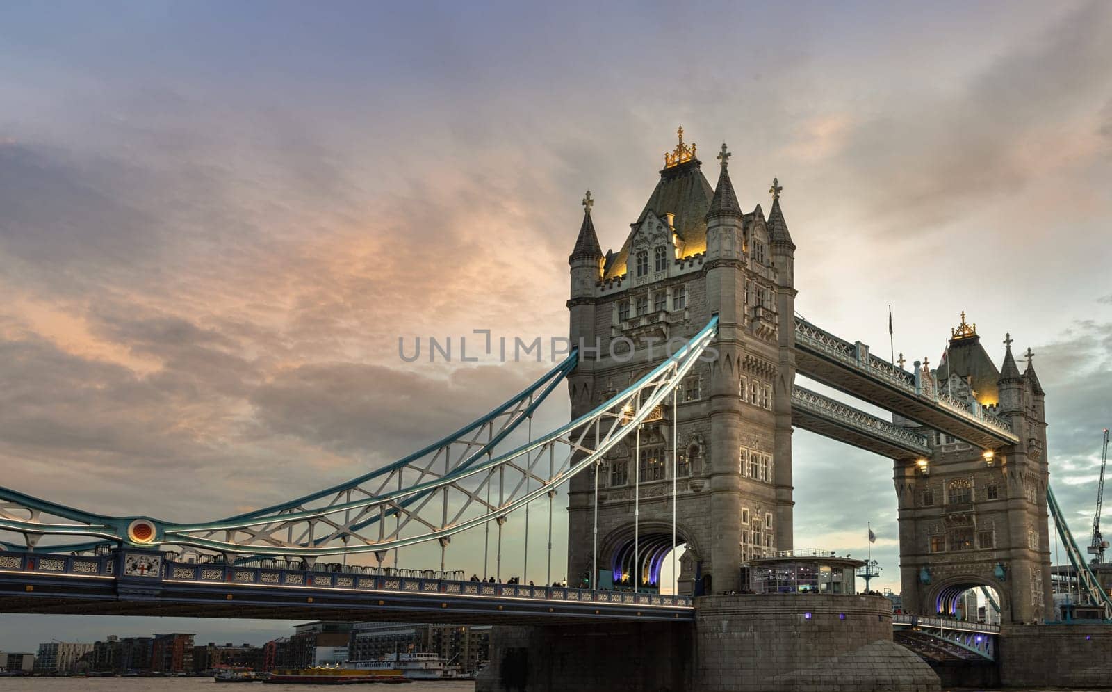 London, UK - Feb 15, 2024 - Beautiful scenery view of famous Tower bridge and skyline with reflections in the river thames just after sunset. The illuminated Tower Bridge, Space for text, Selective focus.