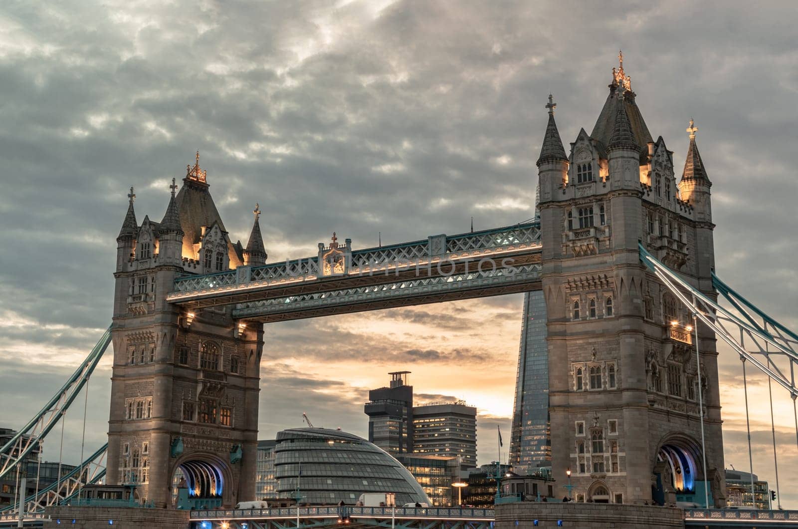 London, UK - Feb 15, 2024 - Beautiful scenery view of famous Tower bridge and skyline with reflections in the river thames just after sunset. The illuminated Tower Bridge, Space for text, Selective focus.