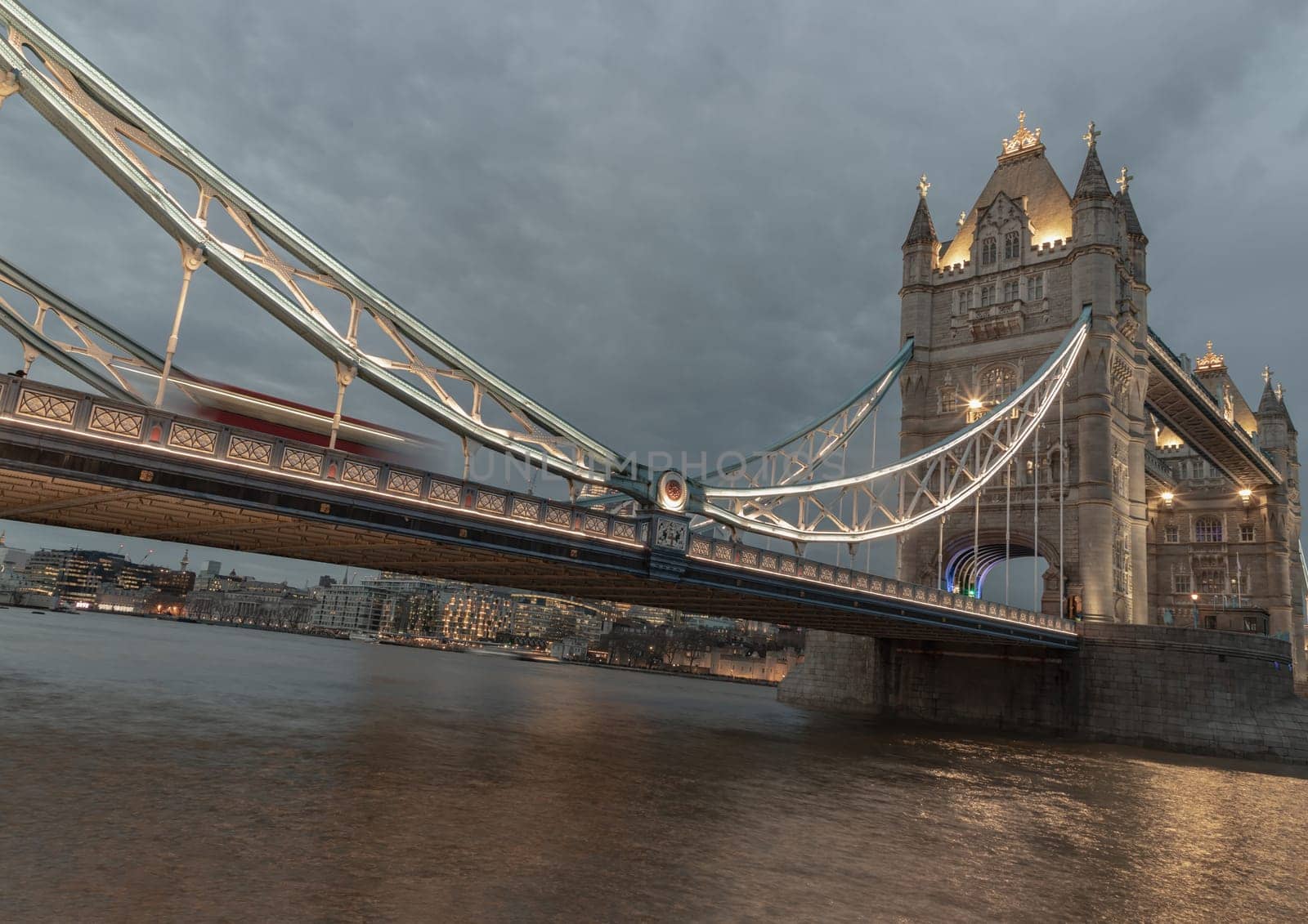 London, UK - Feb 15, 2024 - Beautiful scenery view of famous Tower bridge and skyline with reflections in the river thames just after sunset. The illuminated Tower Bridge, Space for text, Selective focus.