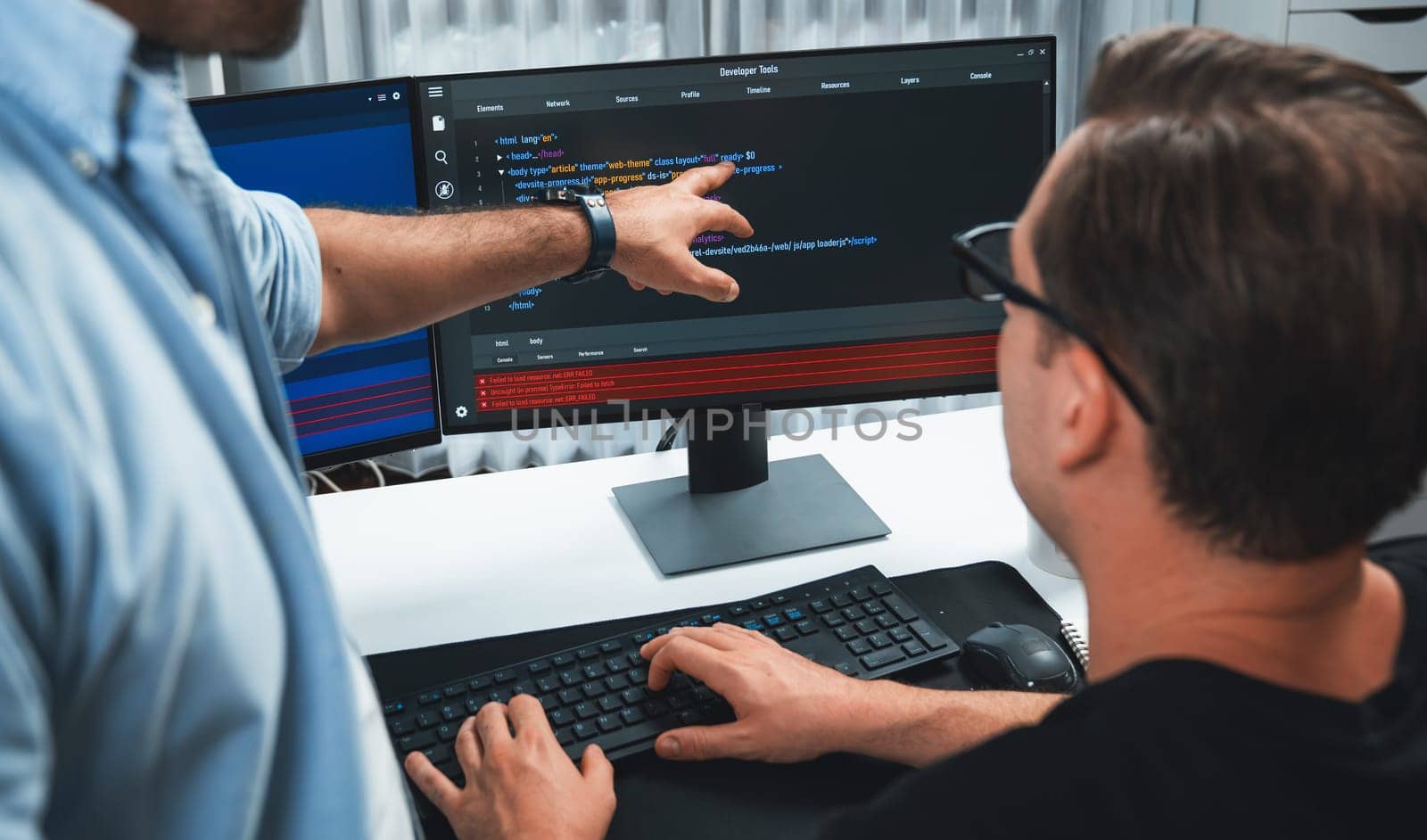 IT developers pointing on software development information on two screens with coding program in application and website. Technical engineer coder analyzing in safety program concept. Sellable.