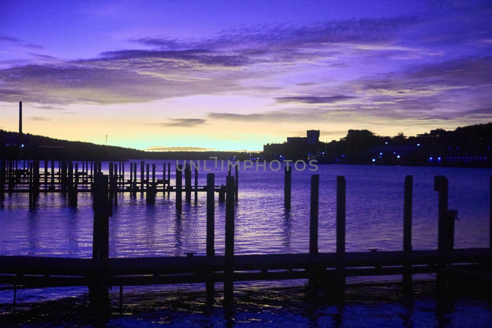 Tranquil twilight scene at a waterfront dock in Houghton, Michigan, reflecting serene purple hues of a sunrise in Fall 2017