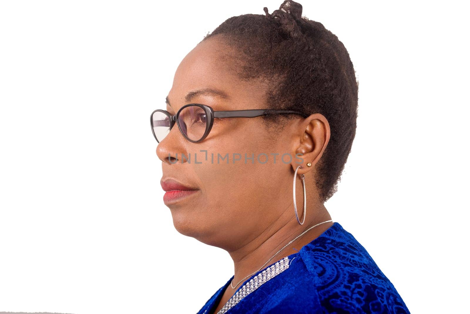 mature woman standing on white background looking to profile.