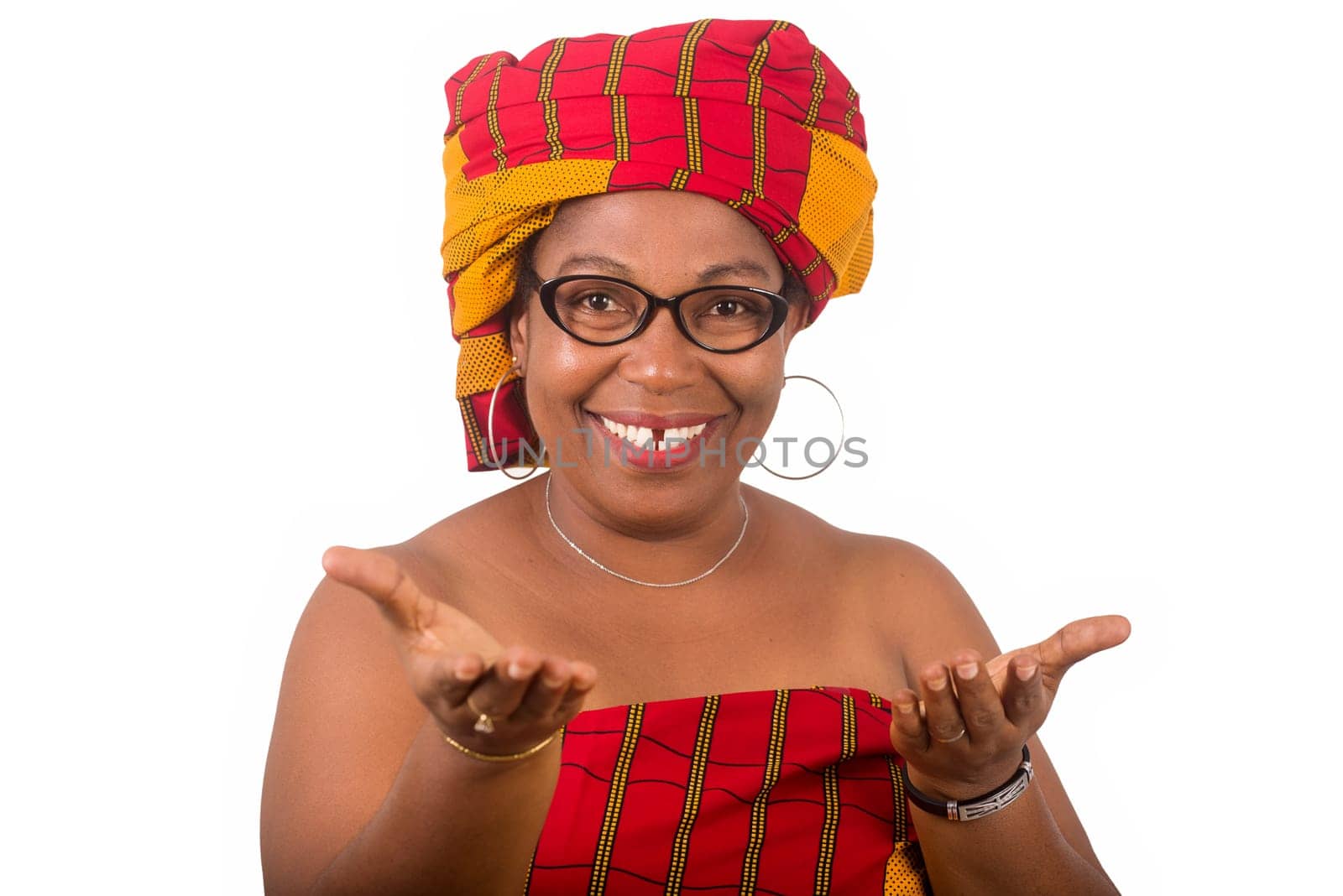 mature woman in glasses standing on white background looking at camera smiling.