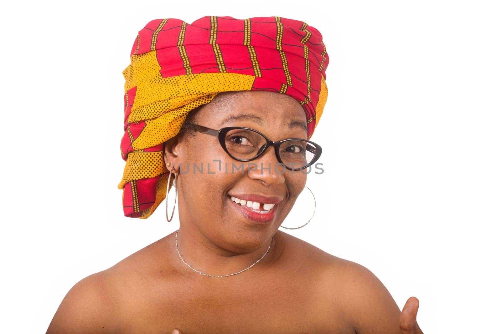 mature woman in glasses standing on white background looking at camera smiling.