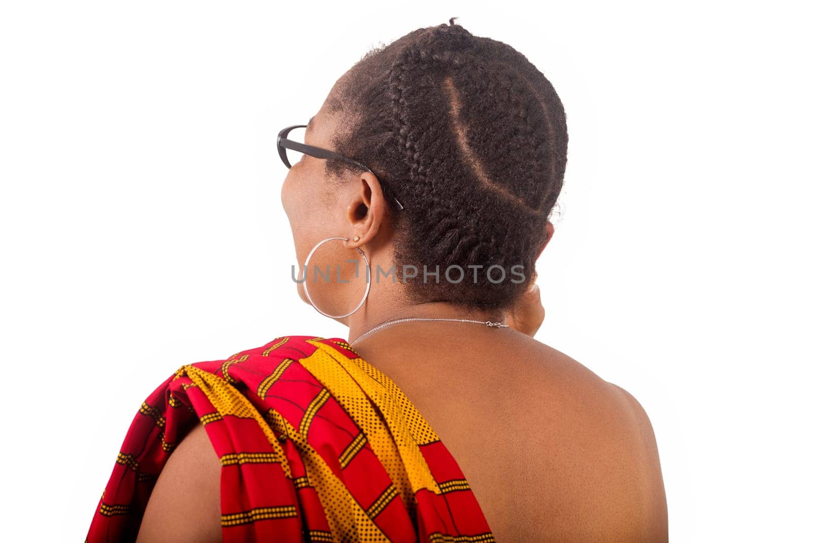 mature woman in traditional clothes standing on white background communicating on cellphone and gives back to camera laughing.