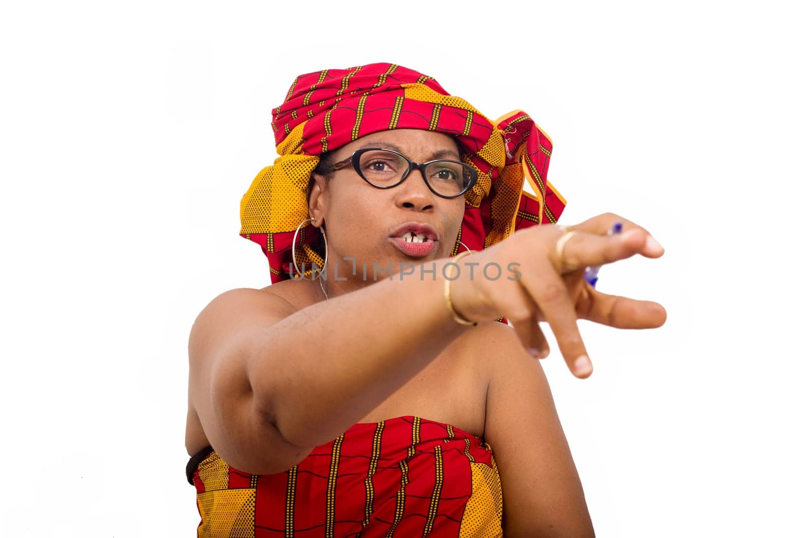 mature woman in loincloth sitting on white background showing something by hand while talking.