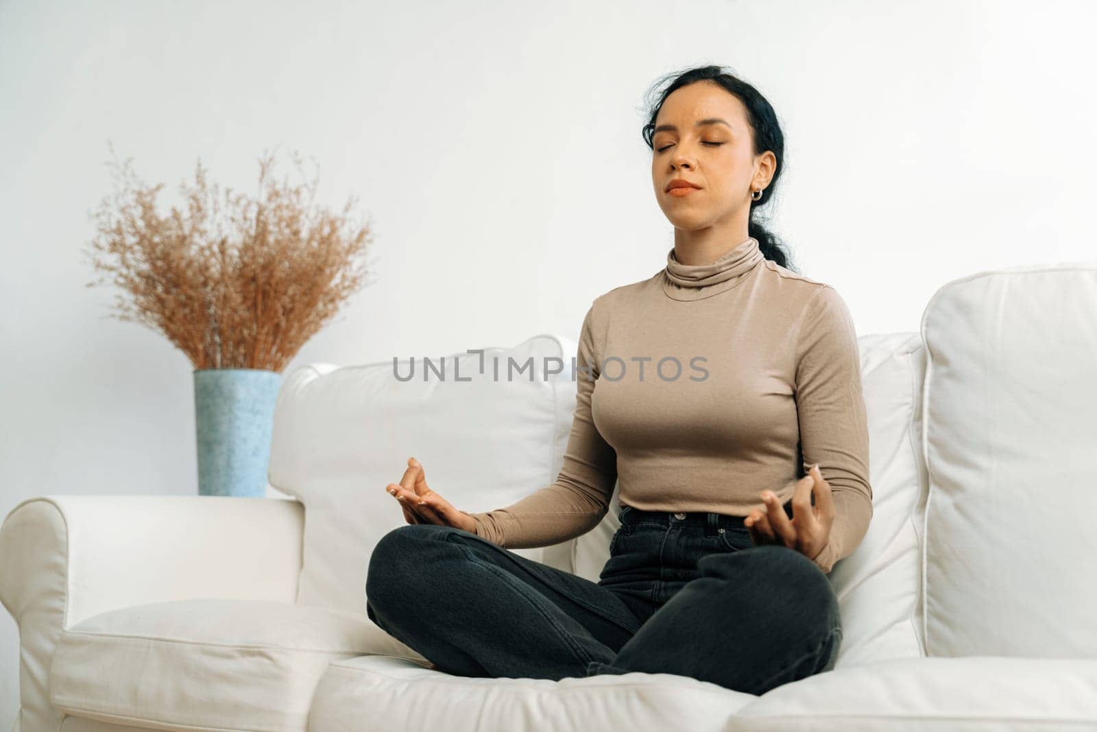 Young African American woman practice crucial mindful meditation at home living room for improving mental health strength and peaceful beautiful living