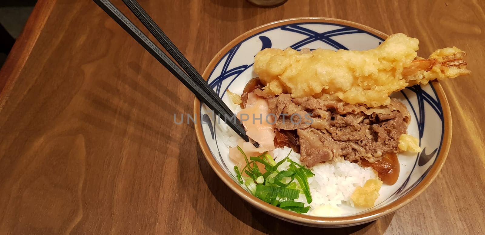 Japanese traditional food beef teriyaki with stickt rice and tempura shrimp sliced spring onion in a bowl