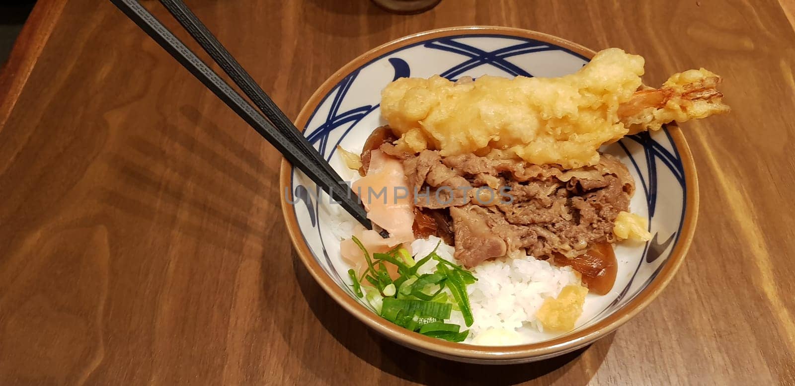 Japanese traditional food beef teriyaki with stickt rice and tempura shrimp sliced spring onion in a bowl
