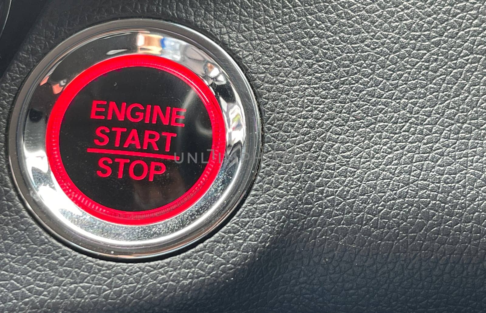 car engine start stop button on dark leather background. copy space Engine Start Button on my car