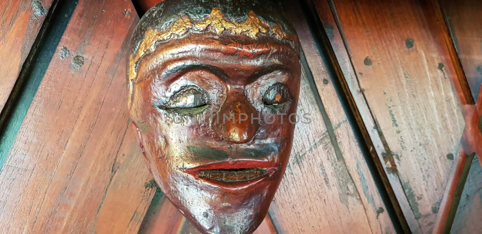 Mystical wooden mask and artworks in traditional retro Javanese style contains spirit of the dead