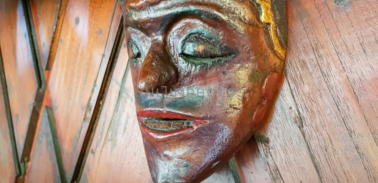 Mystical wooden mask and artworks in traditional retro Javanese style contains spirit of the dead