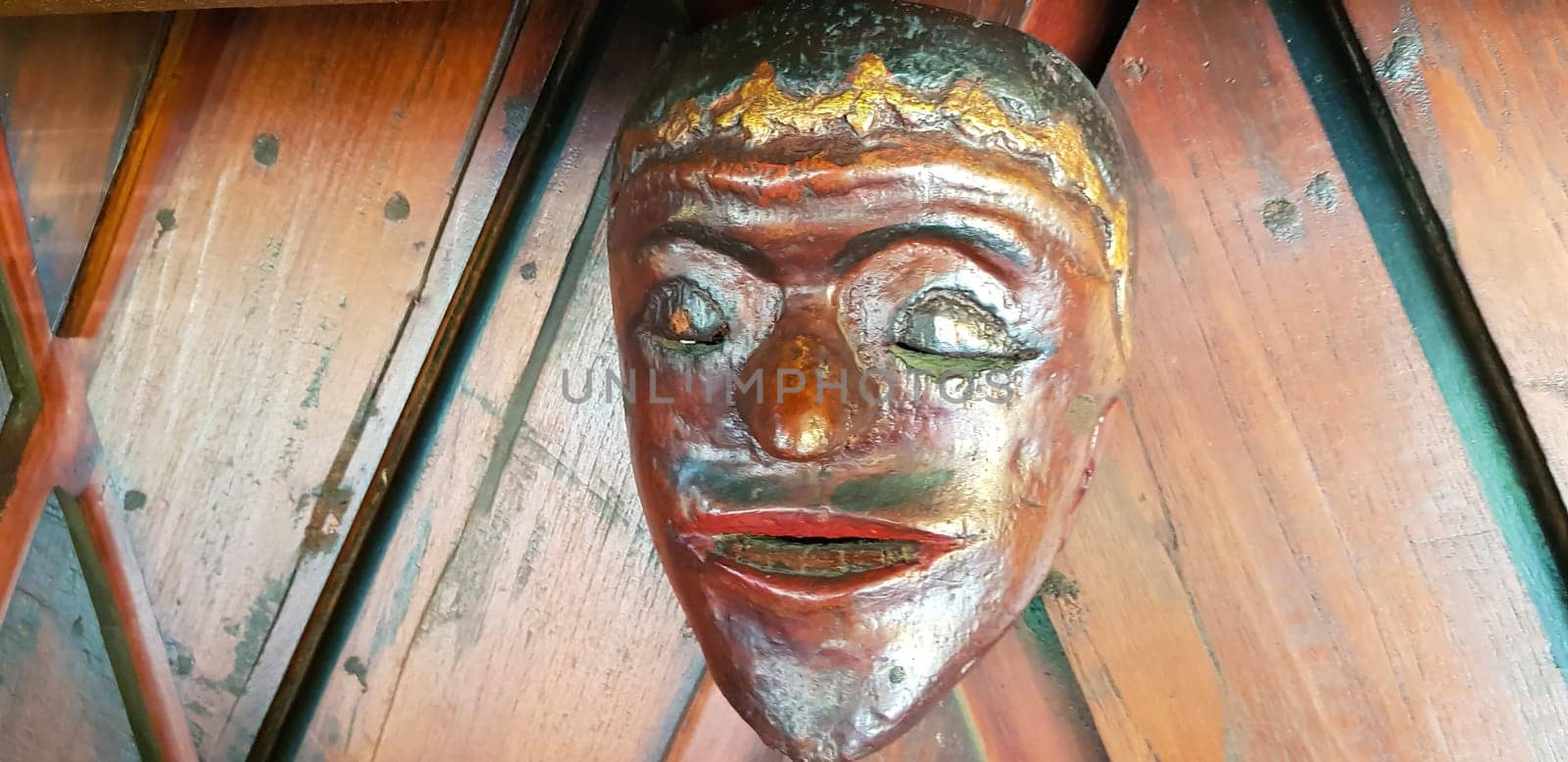 Mystical wooden mask and artworks in traditional retro Javanese style contains spirit of the dead