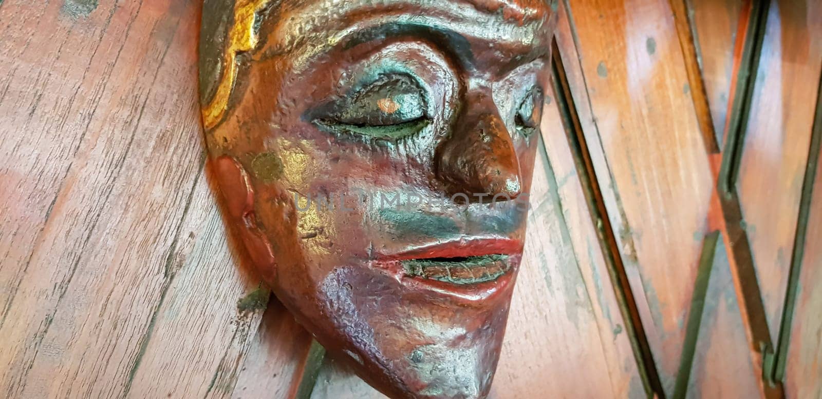 Mystical wooden mask and artworks in traditional retro Javanese style contains spirit of the dead