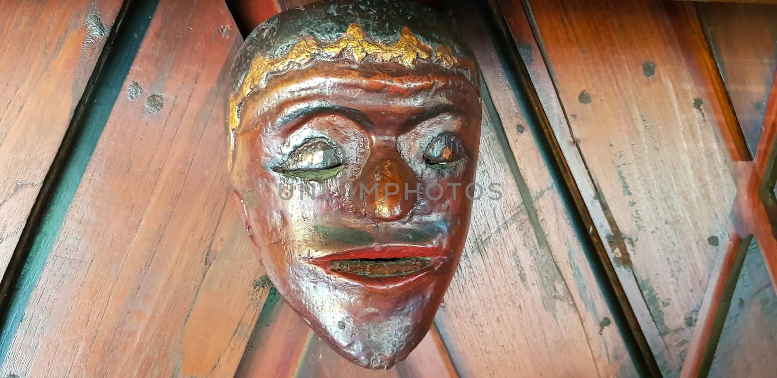 Mystical wooden mask and artworks in traditional retro Javanese style contains spirit of the dead