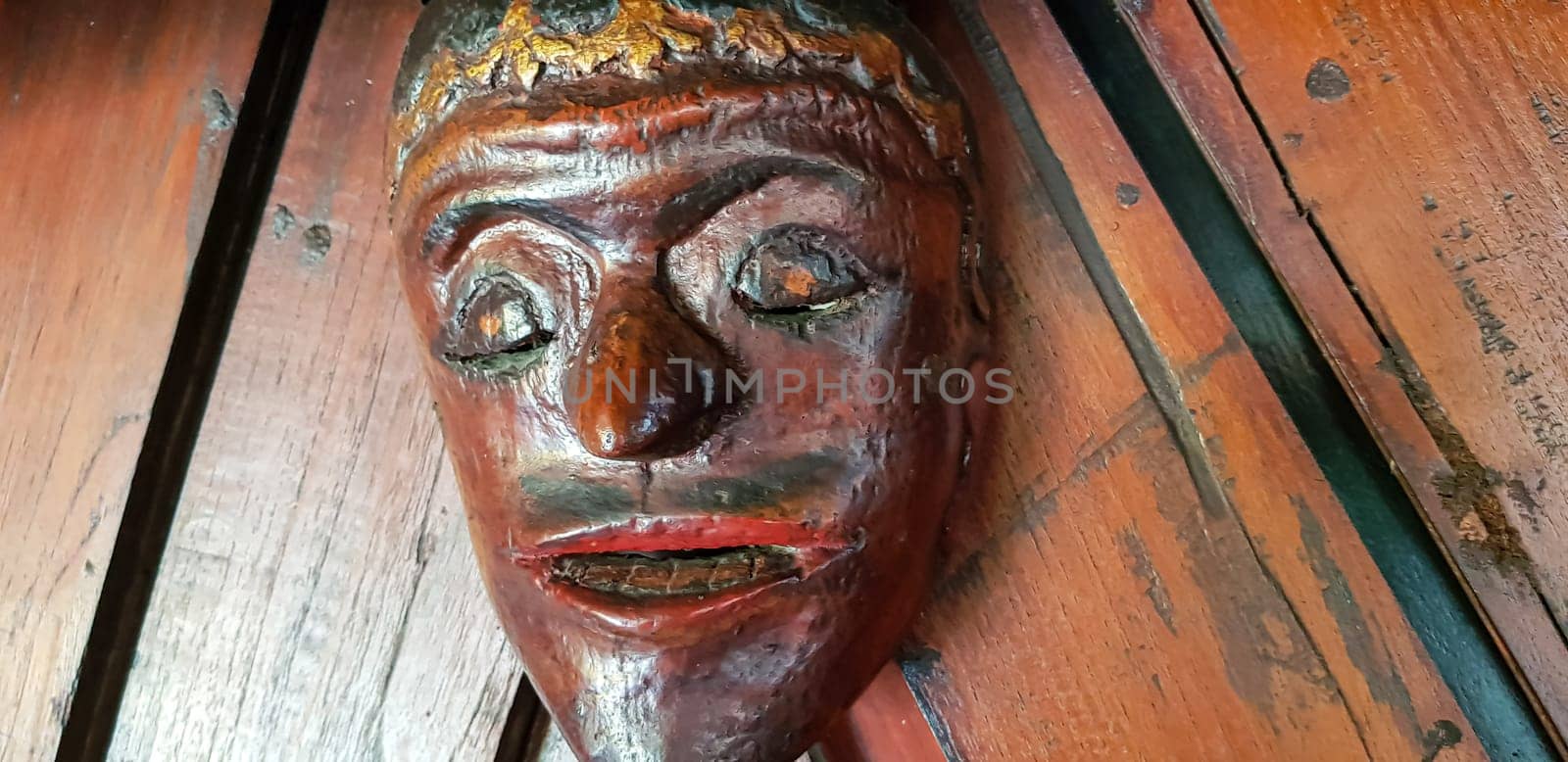 Mystical wooden mask and artworks in traditional retro Javanese style contains spirit of the dead