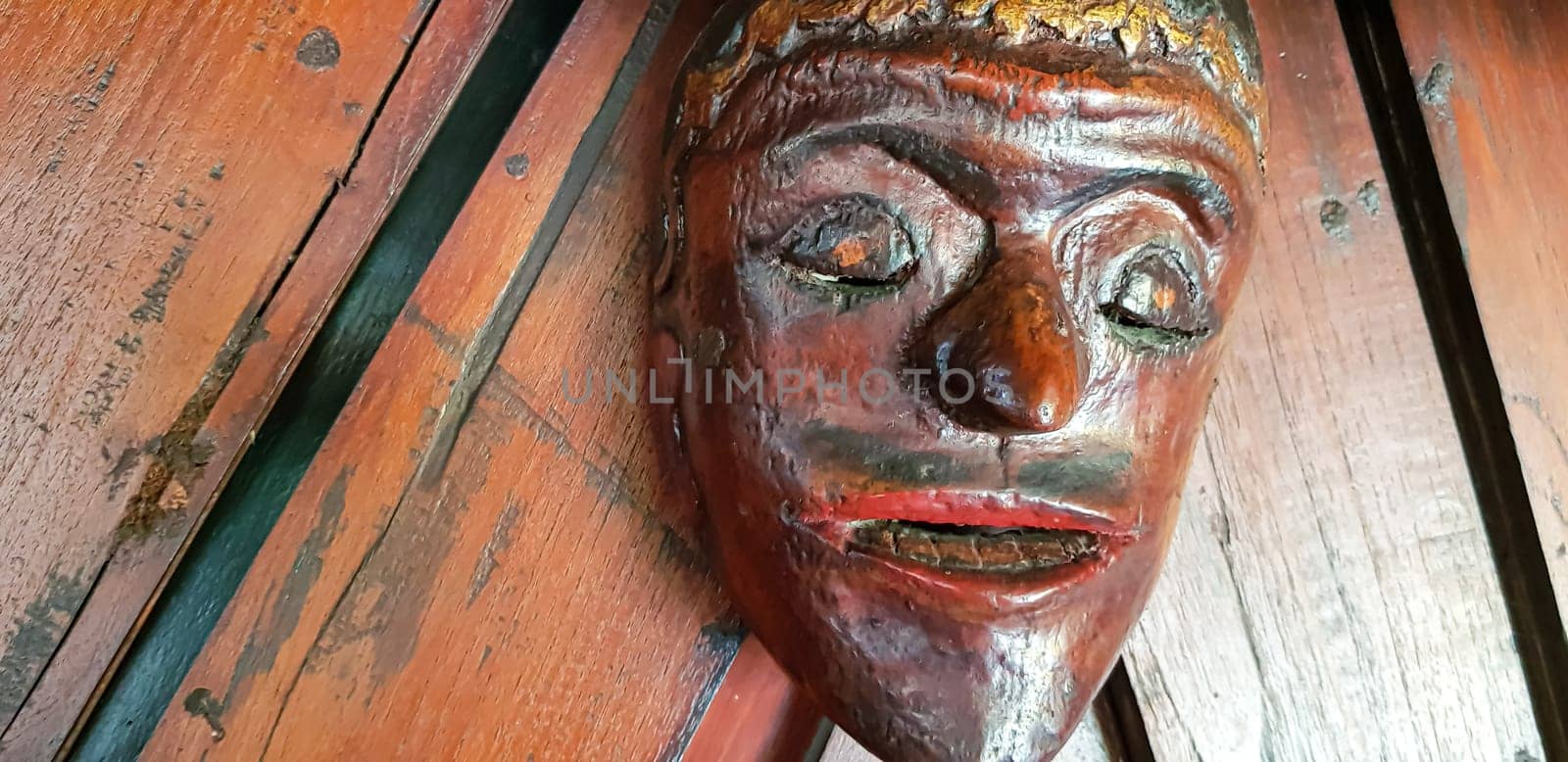 Mystical wooden mask and artworks in traditional retro Javanese style contains spirit of the dead