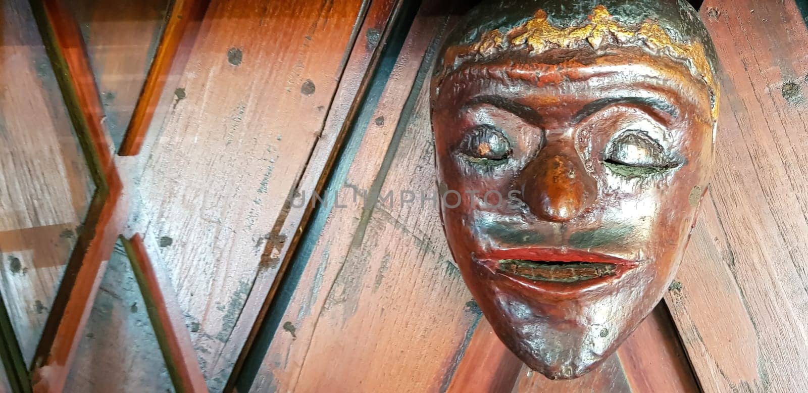 Mystical wooden mask and artworks in traditional retro Javanese style contains spirit of the dead