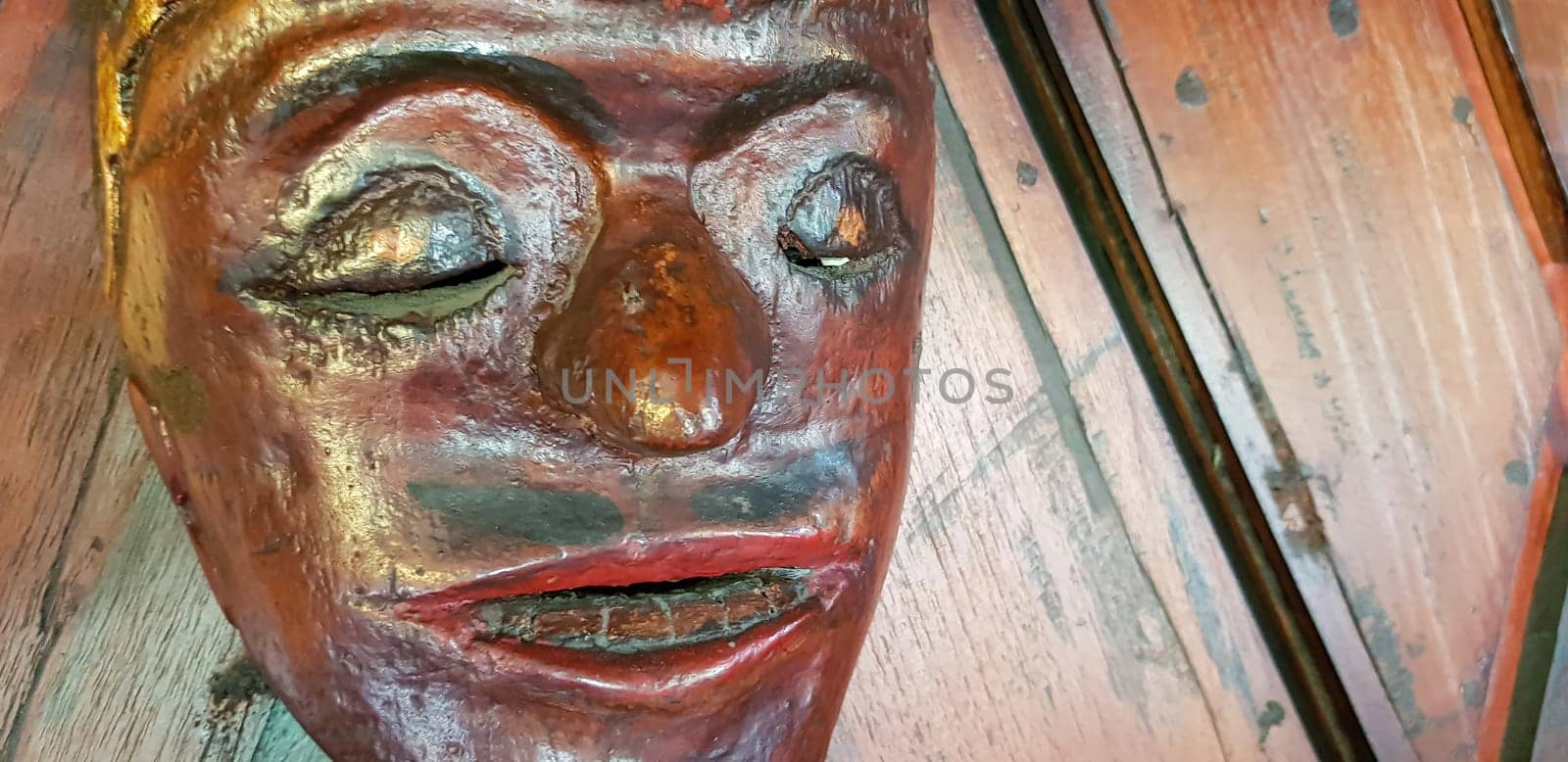 Mystical wooden mask and artworks in traditional retro Javanese style contains spirit of the dead