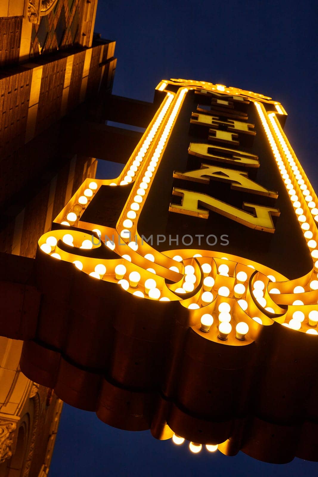 Vintage marquee of Michigan Theater in downtown Ann Arbor glowing against the evening sky, encapsulating the nostalgia of the golden age of cinema.