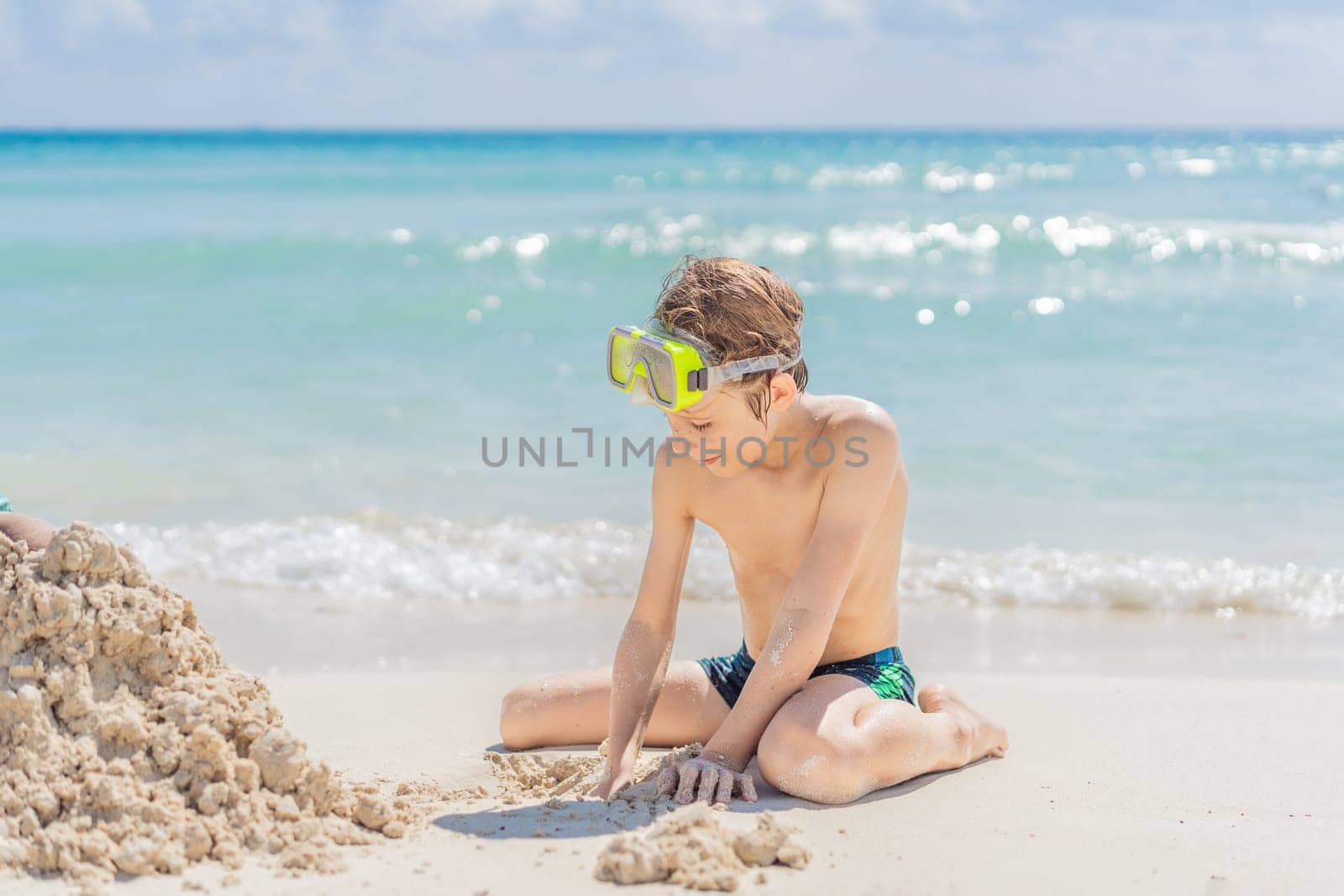 Children boy and girl playing on the beach on summer holidays. Children having fun with a sand on the seashore. Vacation concept. Happy sunny day by galitskaya