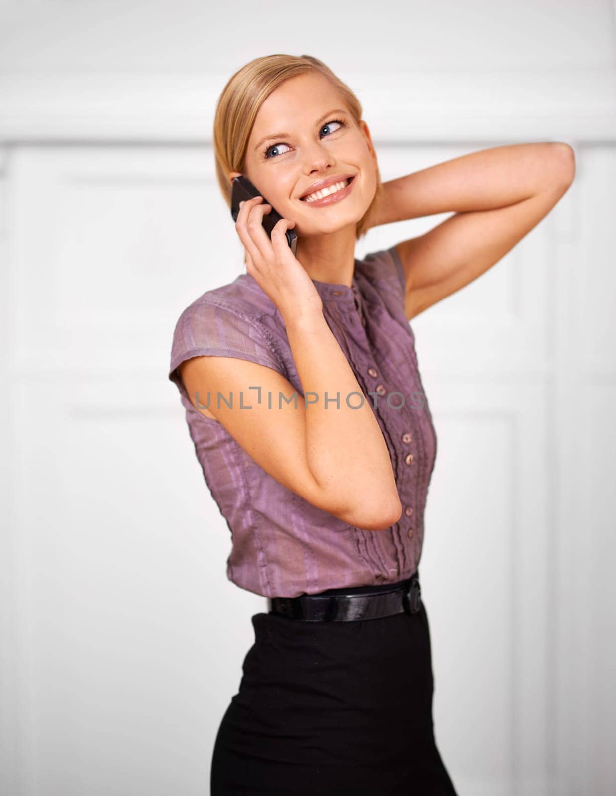 Woman, cellphone call and smile with thinking in office for contact, communication or deal at startup agency. Person, employee and mobile phone for conversation, negotiation or listening in workplace by YuriArcurs