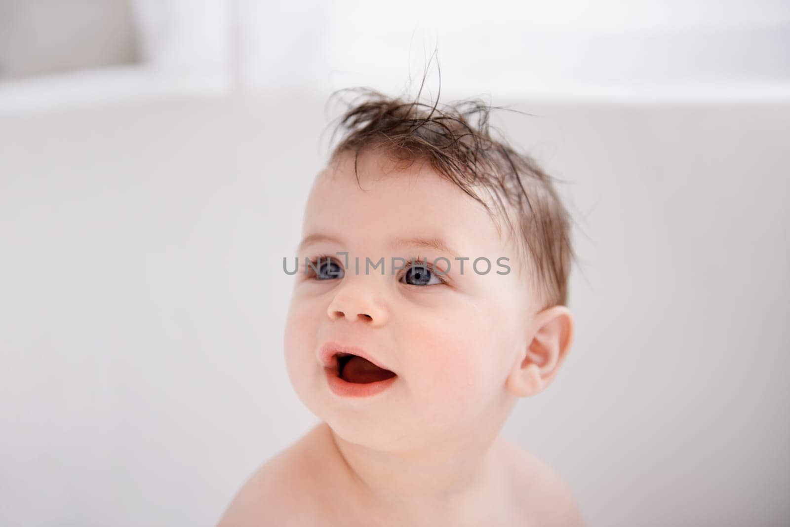 Happy, cute and baby in bathtub at house for infant hygiene, health and wellness routine. Sweet, smile and adorable young boy toddler, child or kid washing body for clean skin in bathroom at home