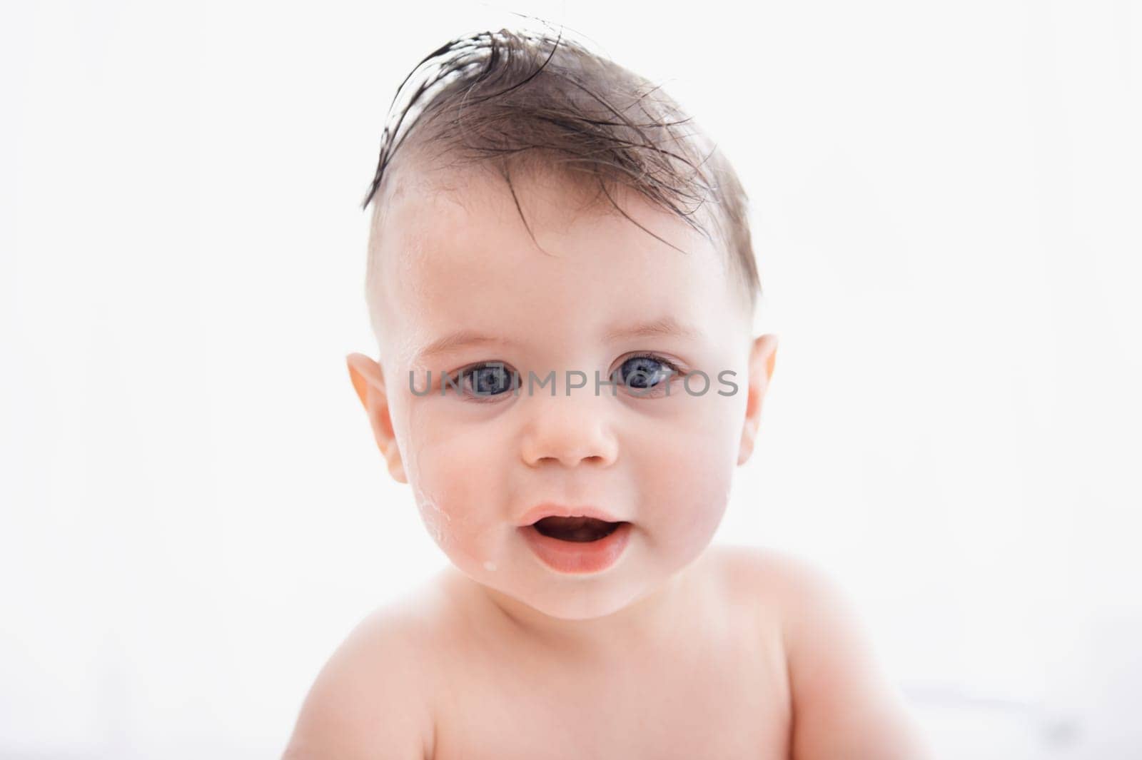 Cute, portrait and baby in bathtub at house for infant hygiene, health and wellness routine. Sweet, happy and adorable young boy toddler, child or kid washing body for clean skin in bathroom at home