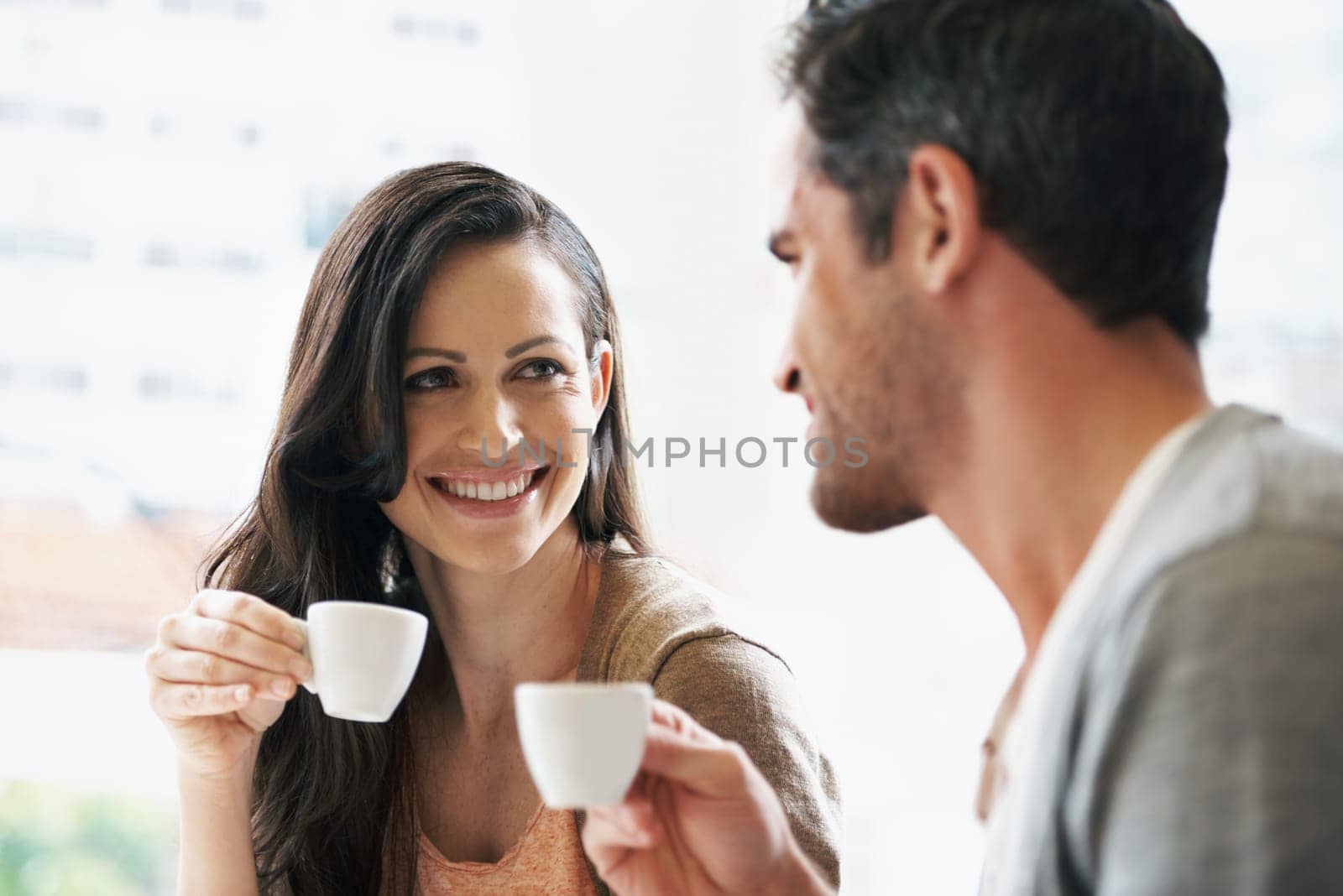 Happy, conversation and couple with coffee on date for romance or anniversary in cafeteria. Love, bonding and young man and woman talking and drinking latte, espresso or cappuccino at restaurant. by YuriArcurs
