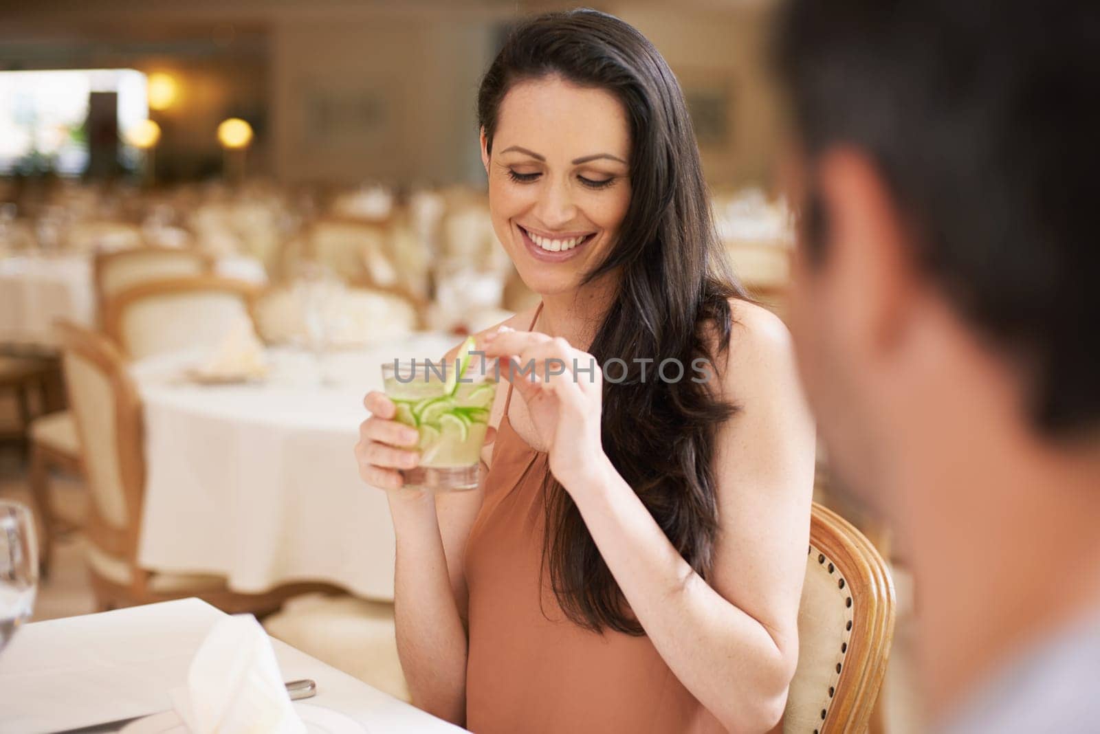 Happy woman, date and drinking alcohol in fine dining, romance or love for anniversary at restaurant. Young woman smile with man on romantic dinner for good beverage, celebration or valentines day by YuriArcurs