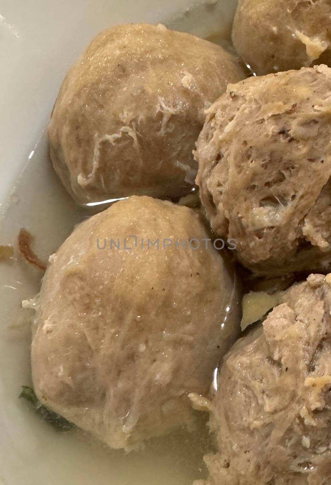 super delicious, tender and juicy and spicy bites of beef tendon meatballs in a bowl in Indonesian street food