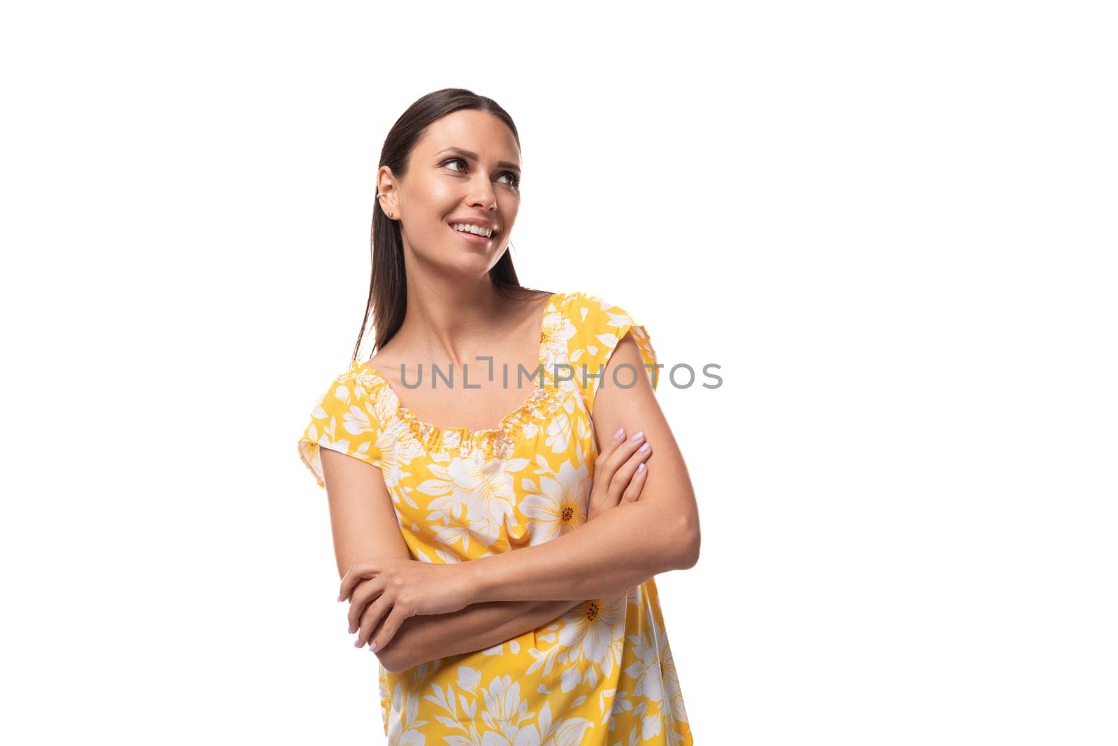 european positive charming brunette lady with loose hair wearing a yellow t-shirt with a flower print by TRMK