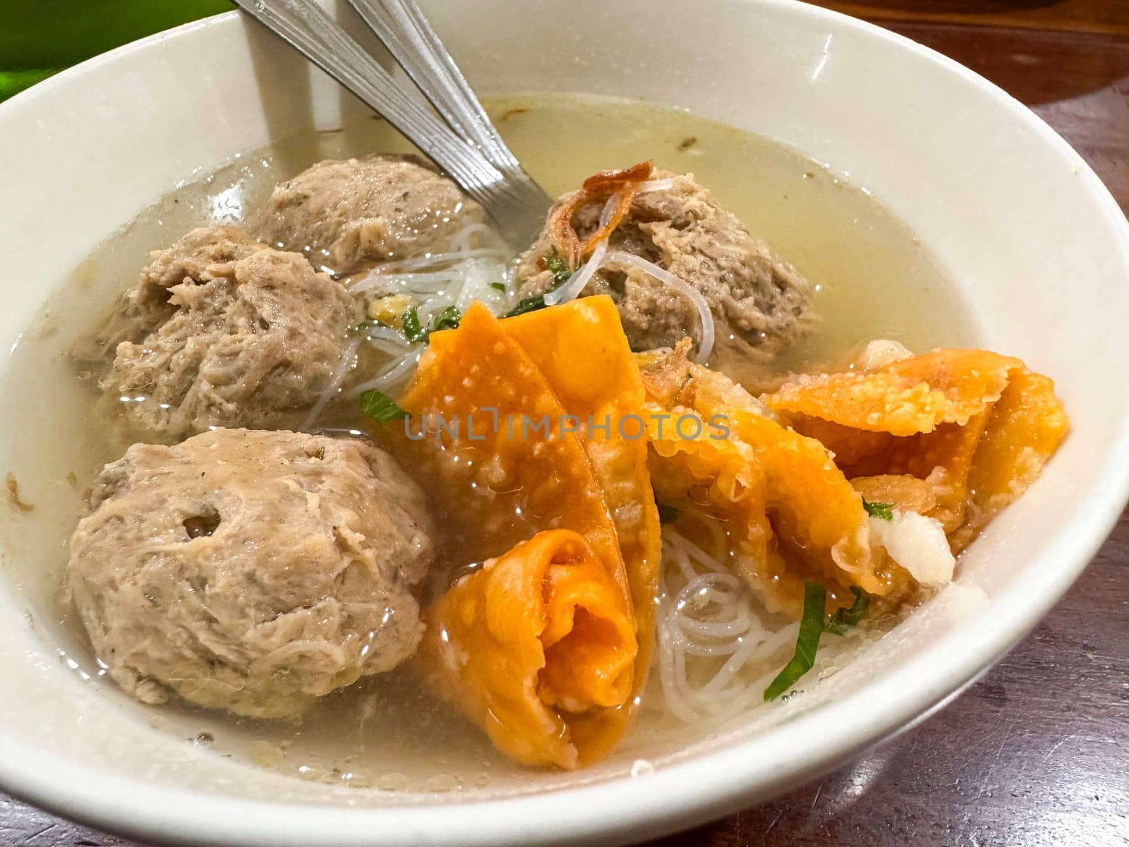 super delicious, tender and juicy and spicy bites of beef tendon meatballs in a bowl in Indonesian street food