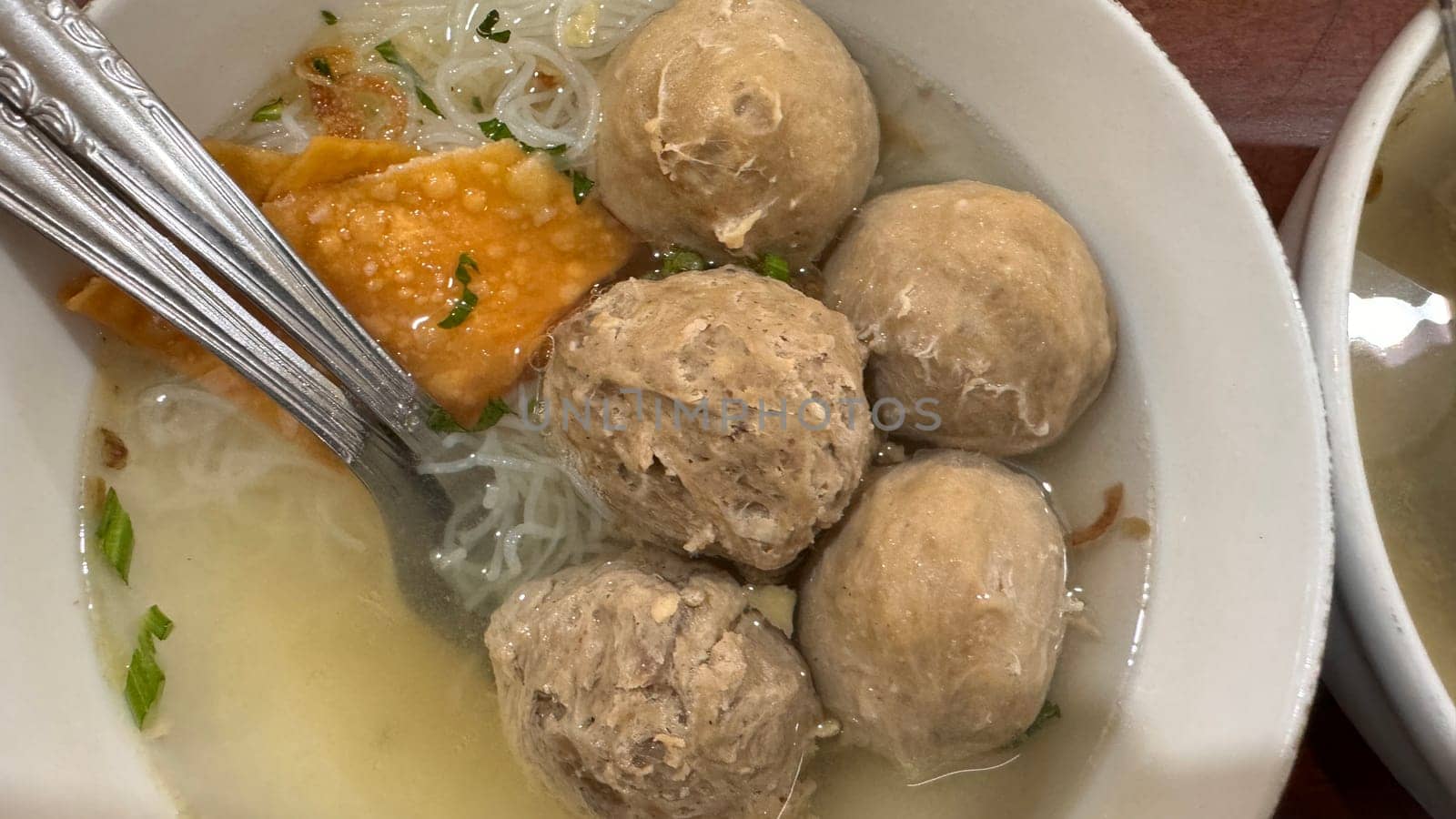 super delicious, tender and juicy and spicy bites of beef tendon meatballs in a bowl in Indonesian street food
