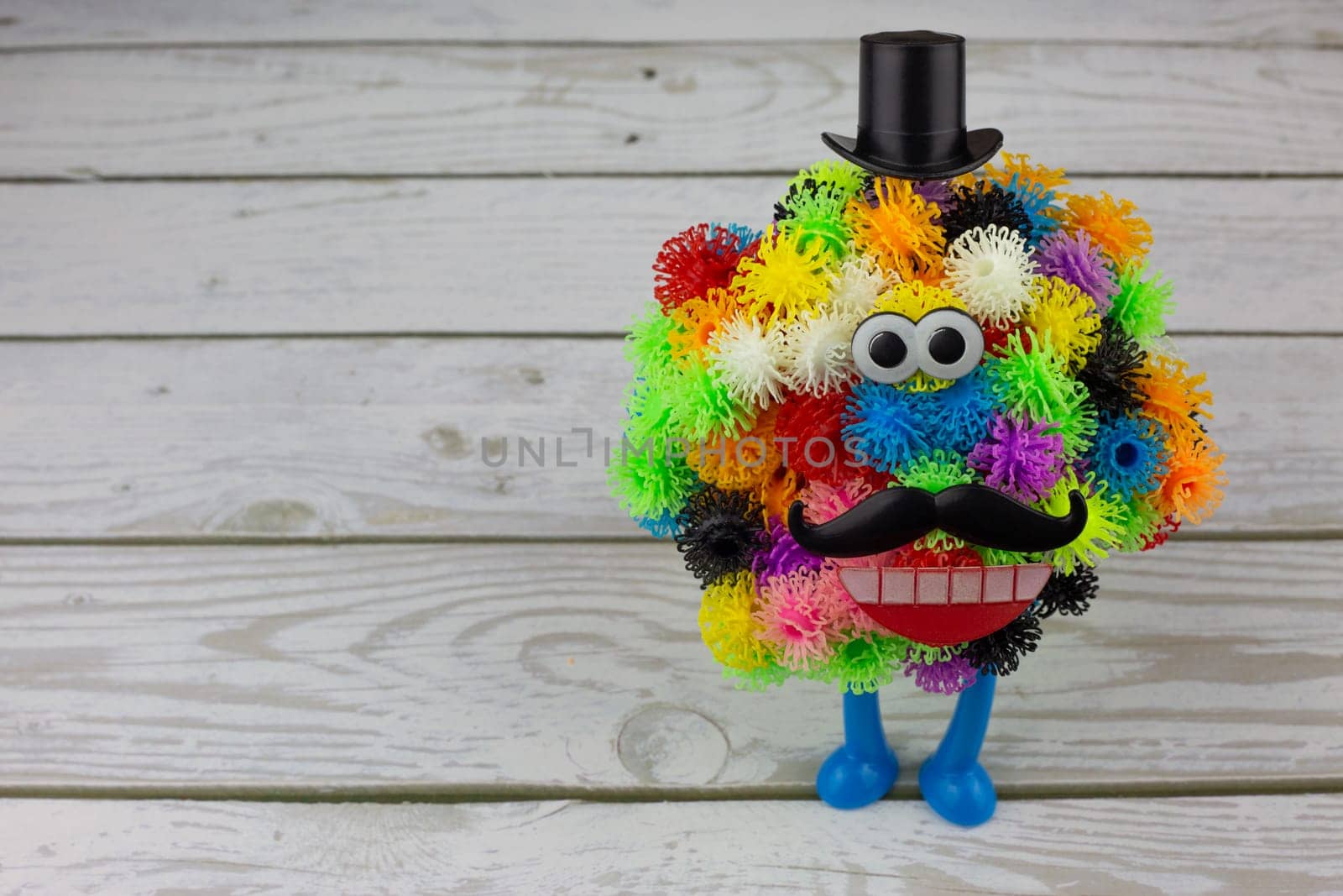 Character made from colored burdocks, modern constructor made from sticky balls with hooks