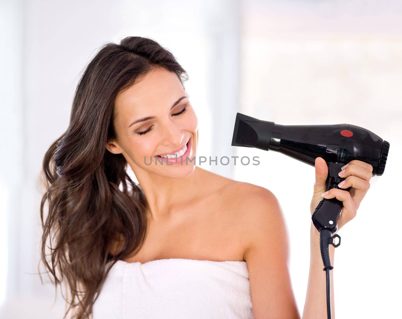 Hair, woman with smile and hairdryer in bathroom, morning routine for grooming and beauty at home. Cosmetology, transformation with electric appliance for blow drying and haircare, texture and growth by YuriArcurs