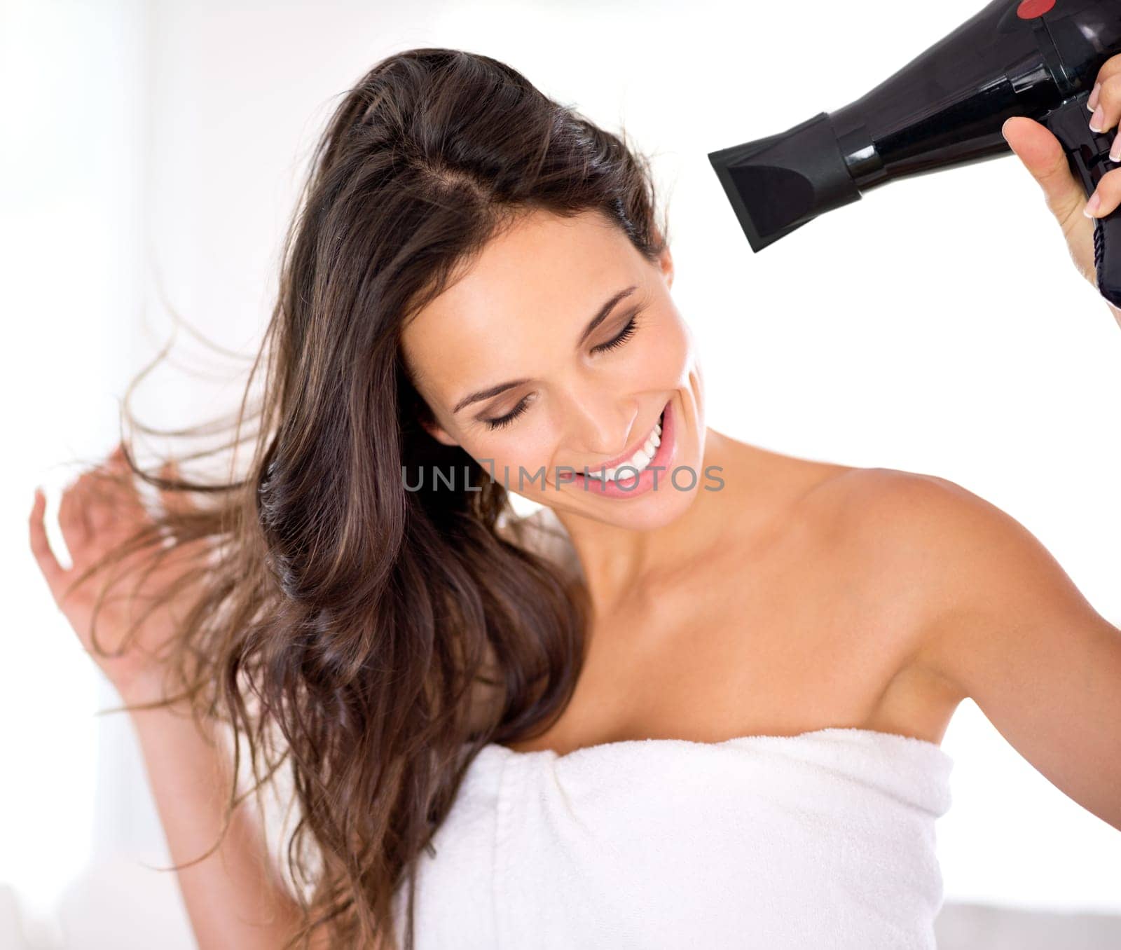 Hair, woman and happy with hairdryer in bathroom, morning routine for grooming and beauty at home. Cosmetology, transformation with electric appliance for blow drying and haircare, texture and growth by YuriArcurs