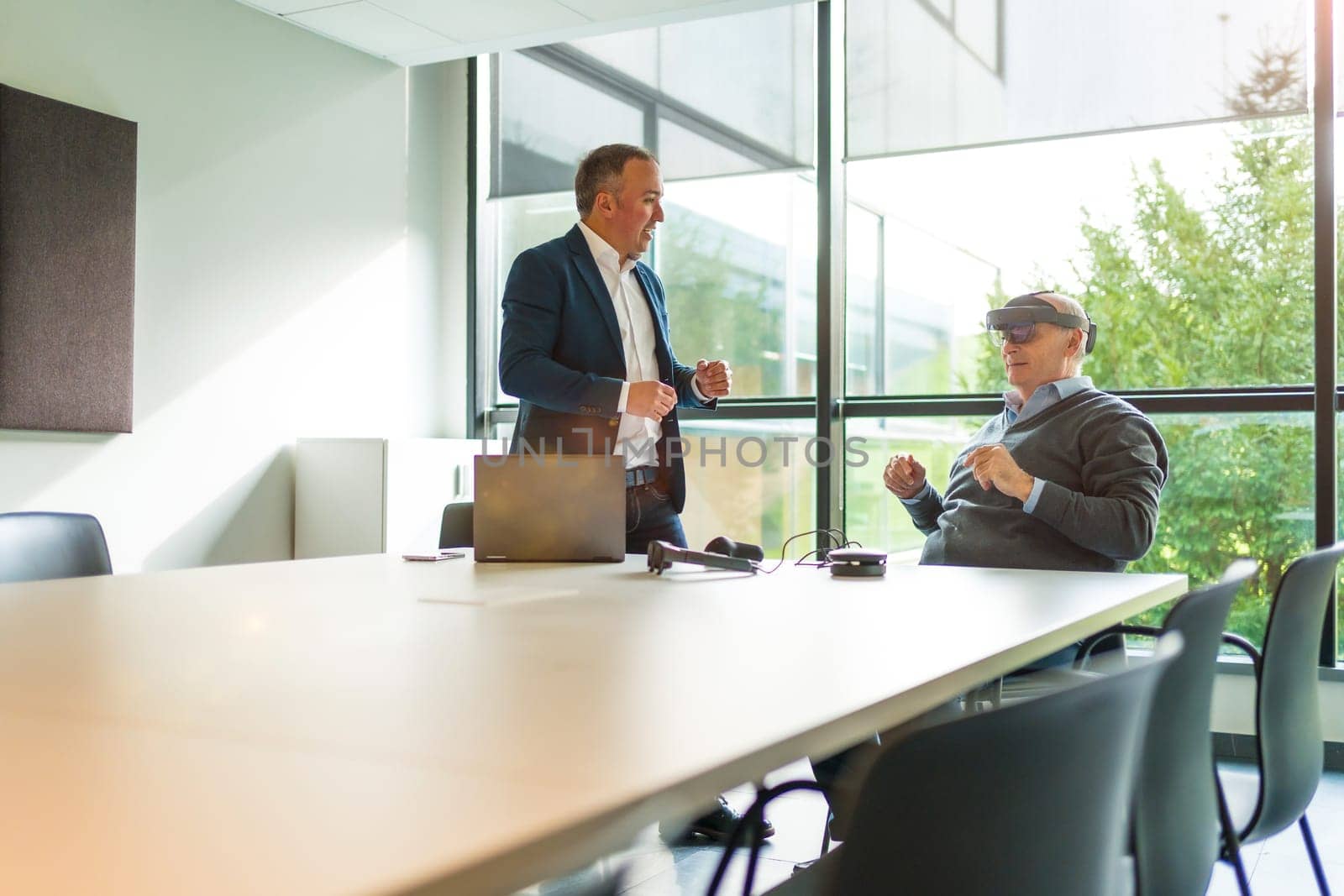 Aged businessmen reflecting the imaginary world with virtual reality in the office