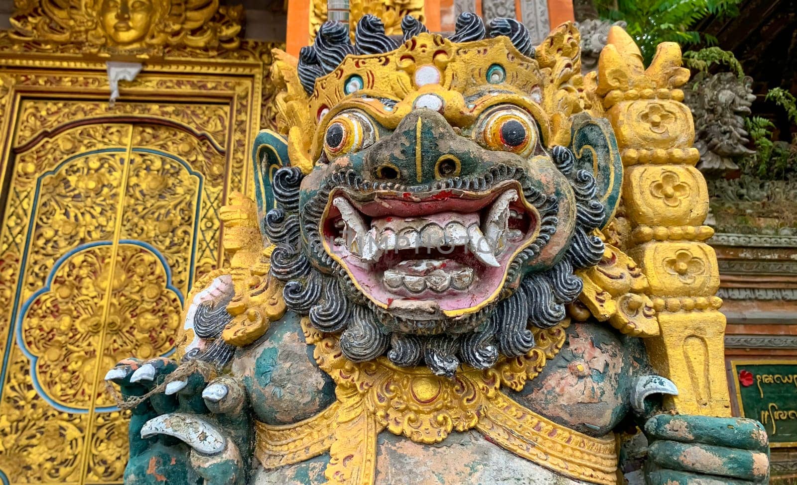 Traditional old ancient Balinese statue of demon angel called barong bali guarding sacred ritual temple of hiduism