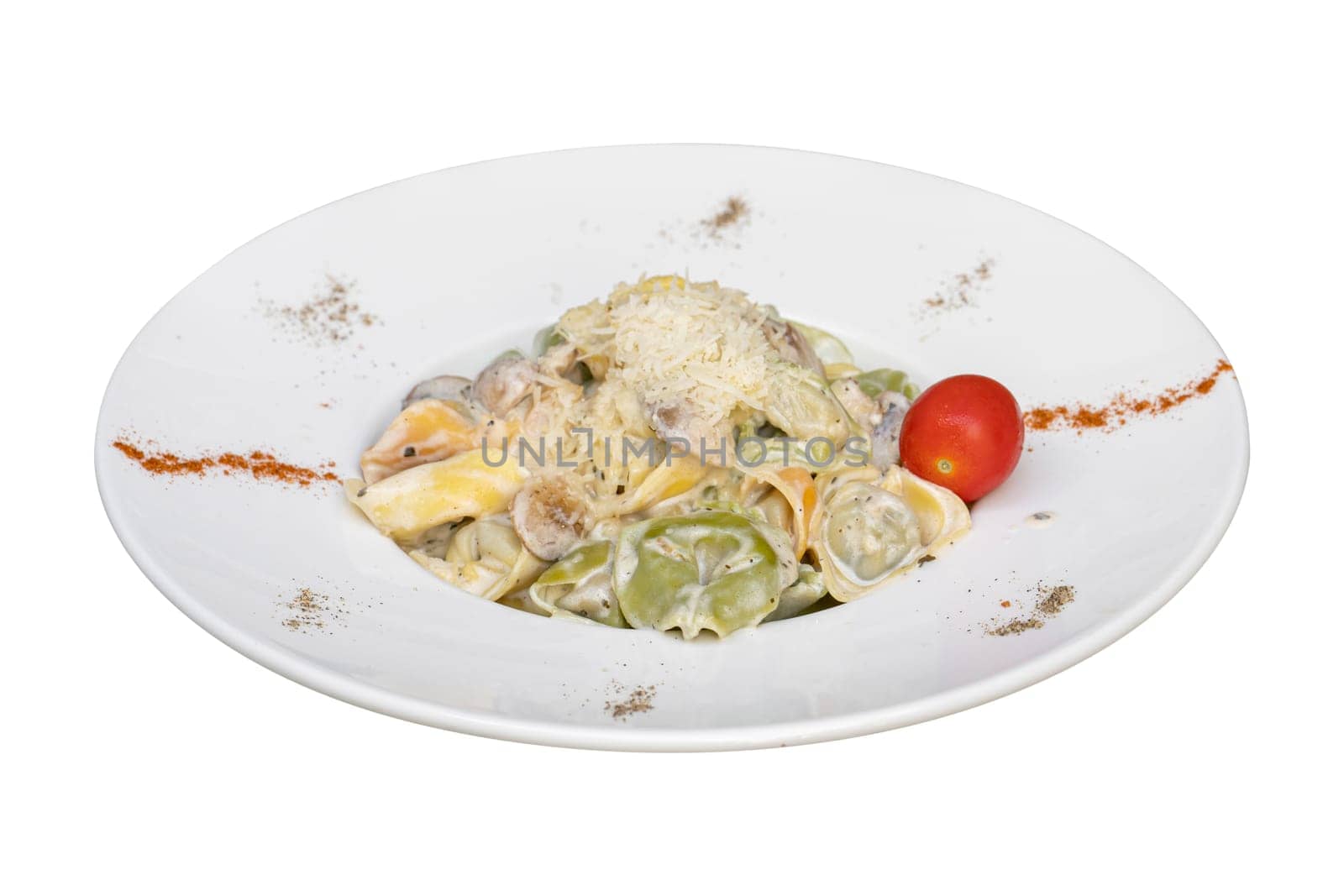 Tortellini with vegetables on white plate on white background by Sonat