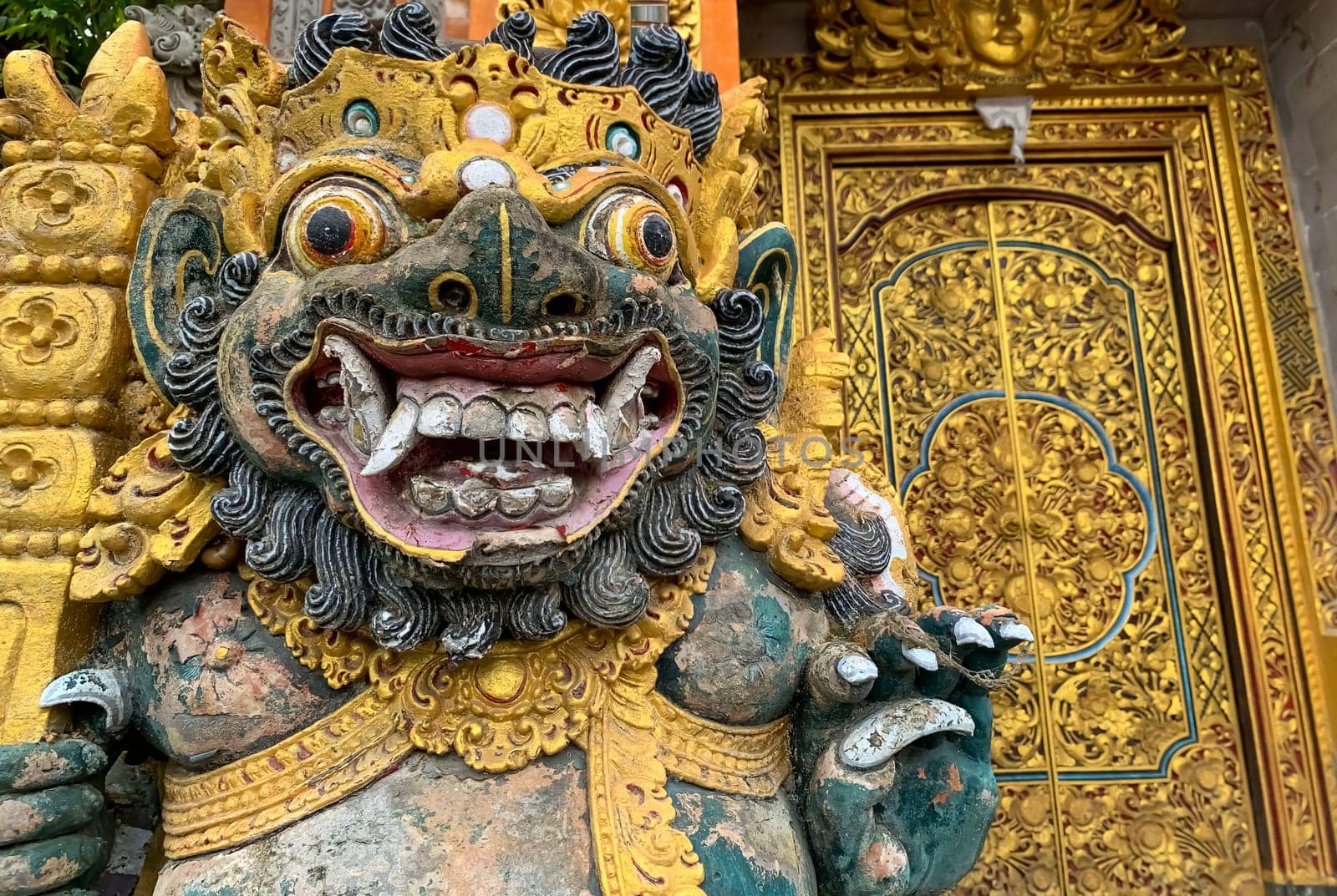 Traditional old ancient Balinese statue of demon angel called barong bali guarding sacred ritual temple of hiduism