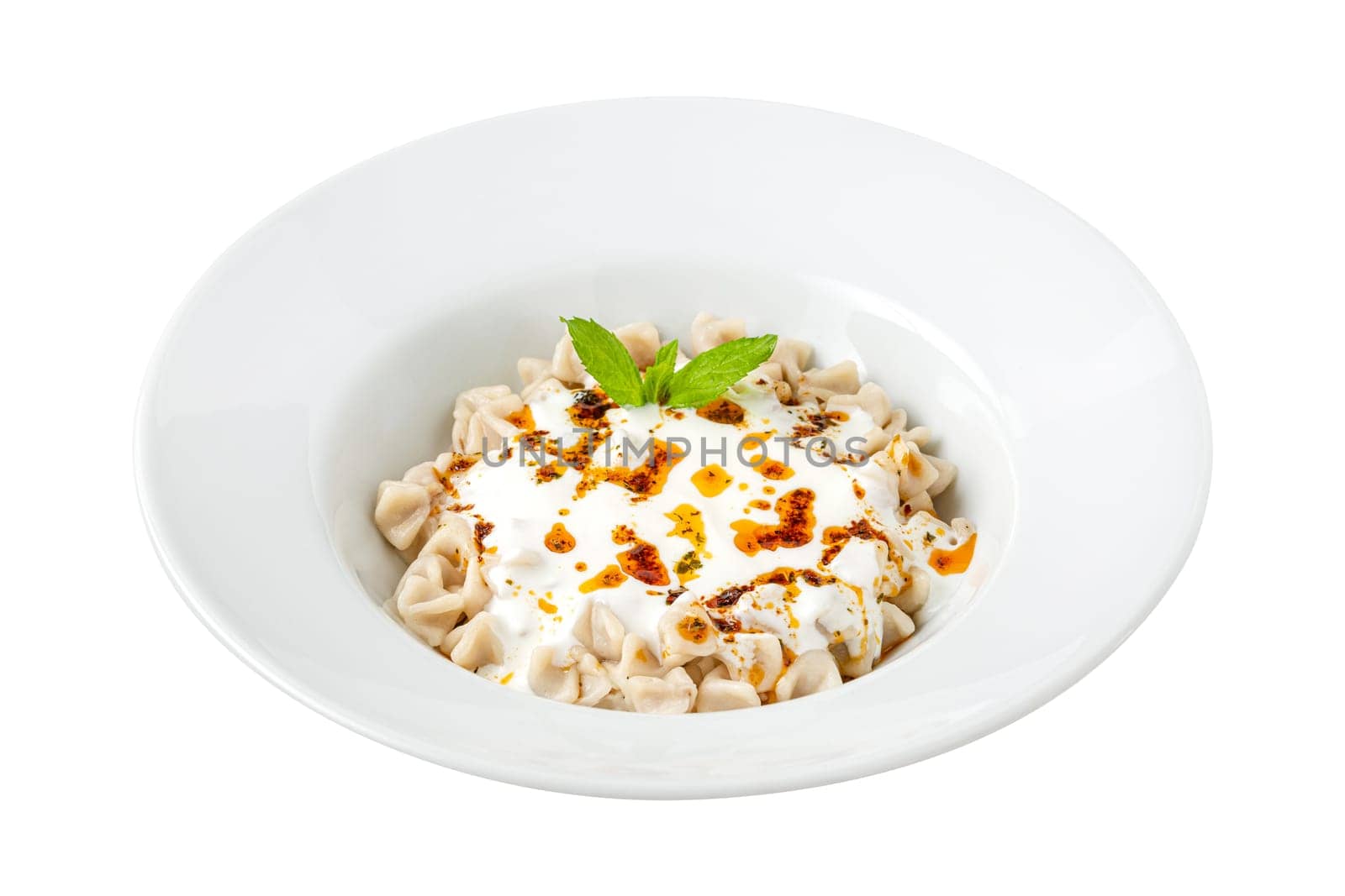 Kayseri ravioli or Kayseri Mantisi on a white plate on white background by Sonat