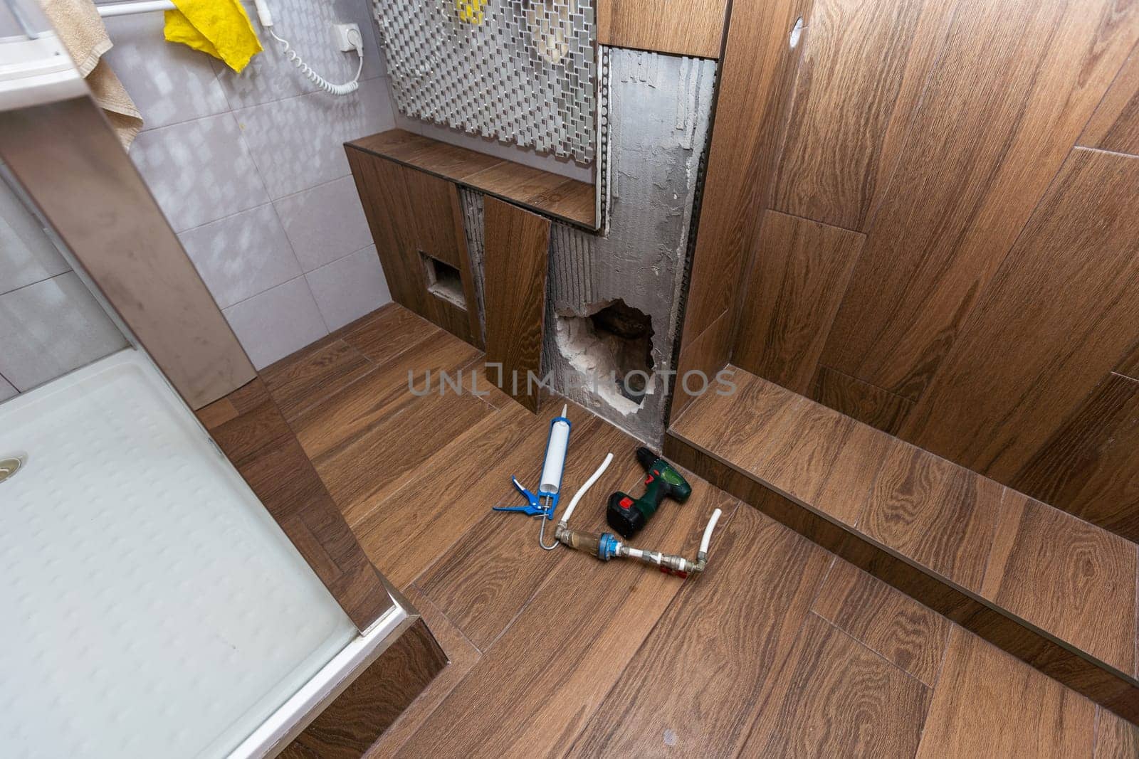 hole into the inside wall and heating pipes . High quality photo