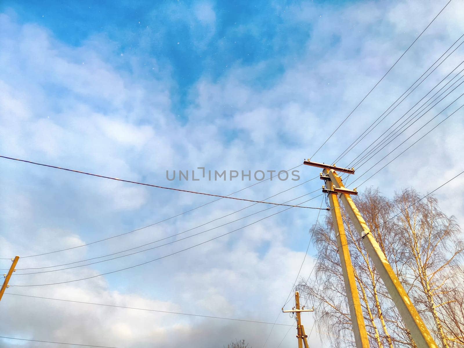 Old pole with wires against the sky. Electric transmission line, Eco-friendly energy
